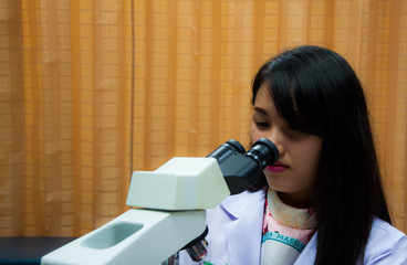 Doctor woman with microscope in laboratory room. Scientific research