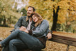 © BGStock72 - Young loving couple on the bench in the autumn park