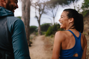 Wall Mural - Fit couple smiling mountain trail