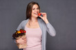 © Yuriy Shevtsov - woman holding paper bag with vegetables eating tomato.