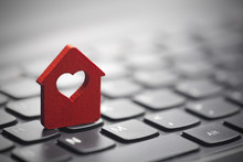 Small Red House With Heart Over Laptop Keyboard 