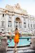 Girl in yellow dress in front of Trevi Fountain, Rome, Italy. Young pretty girl with blonde hair in a yellow dress. Photo shooting in Rome, Italy 