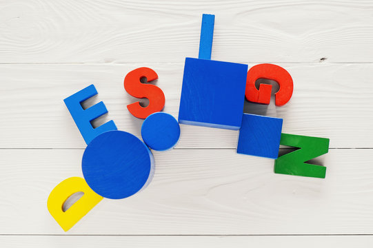 The concept of design word on colorful wooden letters.