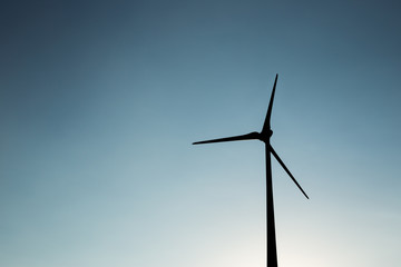 Wind turbine silhouette during sunset