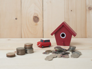 Money coins stack growing with red house on wood background. Business growth investment and financial concept ideas.Real estate investment. House and coins on table.Save money with stack coin .