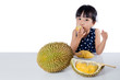 Leinwandbild Motiv Asian Chinese little girl eating durian fruit