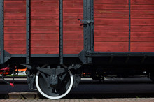 The Side Of The Old Brown Wooden Freight Car With The Wheel Of The Times Of The Soviet Union