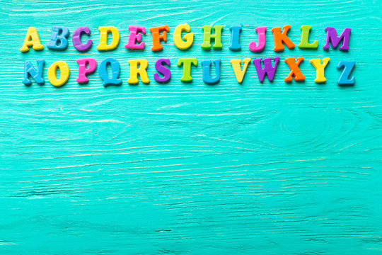 Multiple colored letters on wooden table