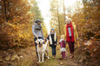 © gpointstudio - Parents and kids walking dog in forest