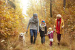 © gpointstudio - Family and their dog in the woods