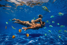 Underwater Image Of A Man And A Girl