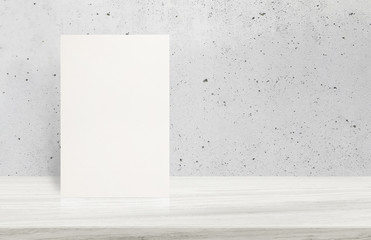 Blank White paper poster on stone table top at grey old concrete wall,Template mock up for adding your design.