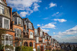 London, England - Traditional brick houses and flats on a nice summer morning with blue sky and clouds taken from Muswell Hill