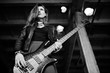 © AS Photo Family - Red haired punk girl wear on black and red skirt, with bass guitar at abadoned place. Portrait of gothic woman musician.