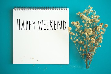 Write happy weekend on notebook.