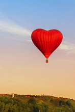 Heart Flying Red Hot Air Balloon In Sunset Sky.