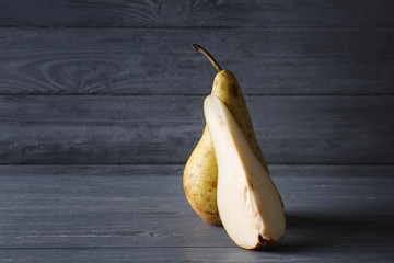 Wall Mural - Yellow pear with piece on wooden table