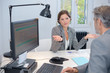 Businesswoman making questioning gesture to male colleague