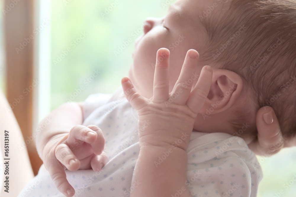 Newborn baby boy with mother at home, closeup