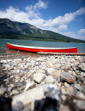 Red Boat On A Mountain Lake