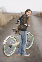 A Young Girl Pushing Her Bike. 