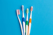 Photo of four multi-colored toothbrushes