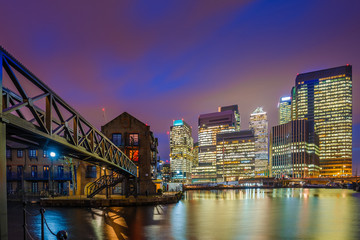 London, England - The skyscrapers of Canary Wharf financial district and residential buildings at the docklands of London by night