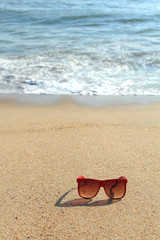 Wall Mural - Red sunglasses on the beach