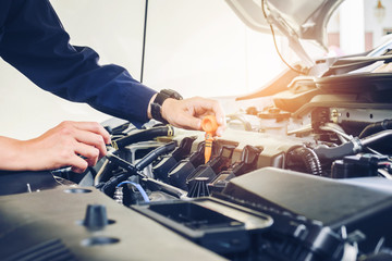 Mechanic changing oil mechanic in auto repair service.