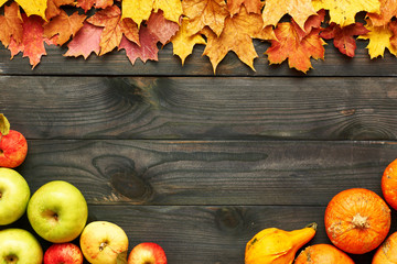 Sticker - Autumn leaves, apples and pumpkins over wooden background