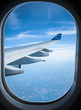 © Micky Wiswedel/Stocksy - Airplane wing and sky from an airplane window