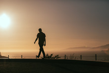 Tourist Overlooks Sunset On California Coast 