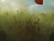 Crowd Throwing Holi Powder In The Air