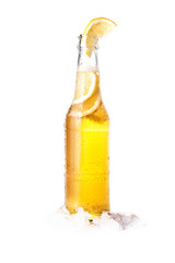 Front view of a bottle of blonde beer with lemon inside and white background