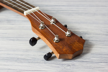 Close up of ukulele on old wooden background