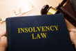 Hands holding insolvency law. Company bankruptcy concept.