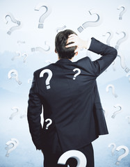 Wall Mural - Thoughtful businessman with questions