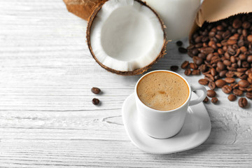 Sticker - Cup of tasty coconut coffee, beans and nut on wooden table