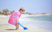 Happy Boy In Beach Towel Playing With Shovel