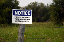 Blue No Trespassing Sign