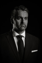 Dramatic Portrait Of Businessman On Black Background In Studio Photo In Black An White