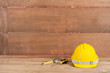 yellow construction safety helmet on wood