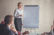 © alfa27 - Confident handsome young businessman giving presentation using flipchart in office