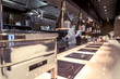 Professional kitchen , view counter in stainless steel . Bokeh .