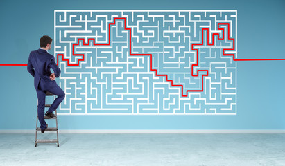Poster - Businessman searching maze solution on a wall 3D rendering