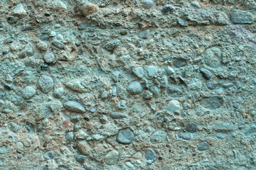 Rough grunge concrete surface painted in blue closeup as background