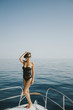 © BGStock72 - Young attractive woman poses on  luxury yacht floating on sea