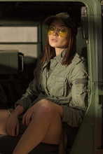 Women In Sunglasses Sitting Inside Tank.
