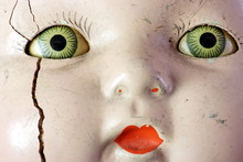 Creepy Old Doll Head With Spooky Green Eyes.