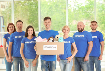 Sticker - Young volunteers with box of donations indoors